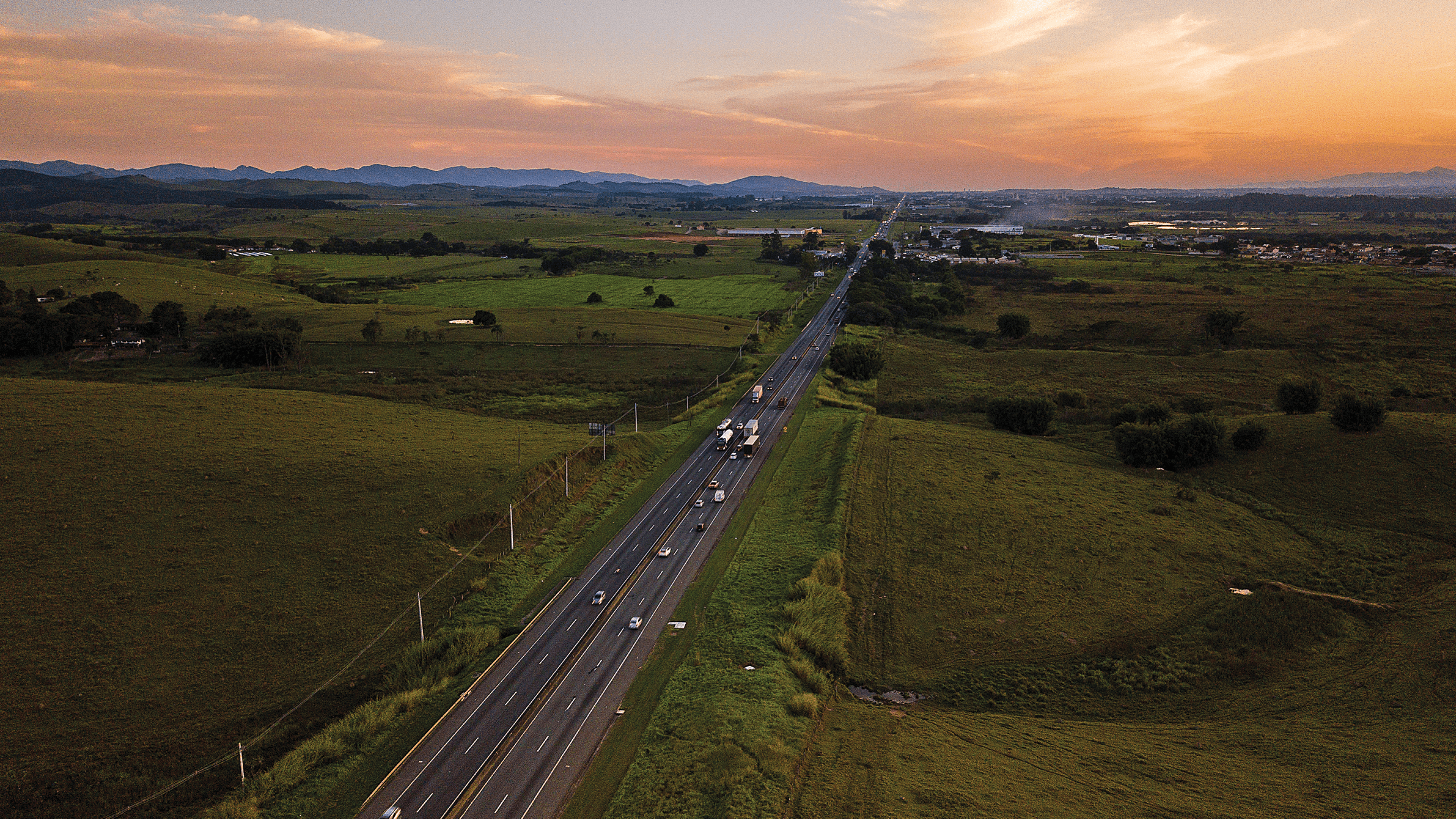 Foto a rea da rodovia com sentido S o Paulo. Ao fundo, pode-se ver a Serra do Mar  esquerda e a Serra da Mantiqueira   direita.
